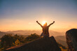 © Mumemories - Young hiker woman relaxing and enjoying the sunset view on top of mountain peak at national park