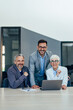 © bnenin - Smiling business people posing for a photo at the office.