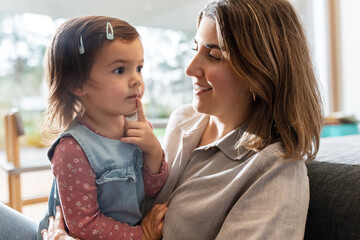 Sticker - family, hygge and people concept - happy mother with little daughter at home