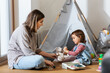© Syda Productions - family, leisure and people concept - happy mother and little baby daughter playing doctor at home