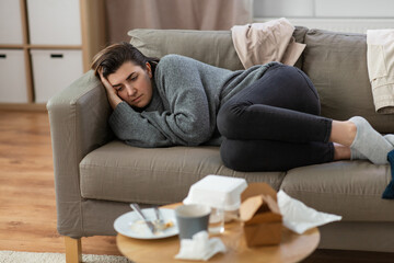 Wall Mural - mental health, psychological problem and depression concept - stressed woman lying on sofa at home