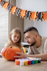  Parent with little kid preparing for holiday Halloween.