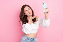 Photo Of Young Charming Romantic Girl Wear Casual Stylish Look Send Air Kiss In Phone Isolated On Pink Color Background