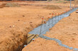 An during construction of a house, the foundation for the construction site is being reinforced with strips