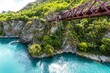 Mesmerizing view of Kawarau Gorge Suspension Bridge over turquoise water, South Island, New Zealand