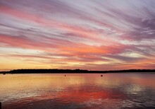 Sunset At Tin Can Bay Qld - Purple And Orange Steaking Clouds, Reflected In The Bay