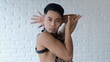 © Sia - A sensual guy in a leather suit with chains expressively shows vogue poses. People's lives are not of traditional sexual orientation. A transgender loves himself for who he is. Homosexual model.