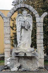 Wall Mural - Angel in the arch with book and broken cross in Chortkiv town Ukraine