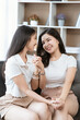 © Kritdanai - Asian lesbian couple, LGBTQ. Happy Two young Asia women showing love and romance together at home. Positive mood and moment of LGBT lesbian