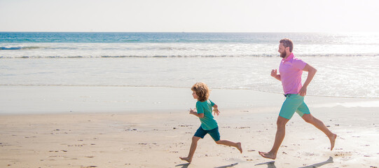 Wall Mural - Father and son run on summer beach outdoor, banner poster with copy space, happy dad and child have fun outdoors. father and son running on summer beach.