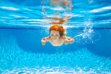 Child Swim Under Water In Sea. Kid Swimming In Pool Underwater. Happy Boy Swims In Sea Underwater, Active Kid Swimming, Playing And Diving, Children Water Sport.