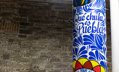 Big post pilaster with traditional mexican talavera pottery style adornments with the inscription 