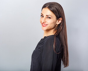 Beautiful happy smiling business woman with toothy smile in black shirt looking on black background with empty copy space. Closeup portrait