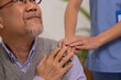 © sopradit - Close up hand of hands of nursing aide holding and patting winkled hand of a patient.Domiciliary care for sick elderly.