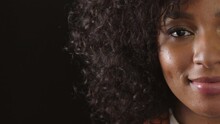 Closeup Of Smiling Afro Woman With Dimples And A Kind, Friendly Or Caring Facial Expression Towards Humanity. Half Portrait, Headshot Or Face Of Happy, Content Lady Against A Black Background