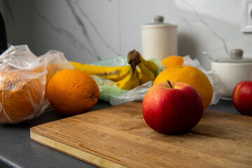 Wall Mural - Fresh fruits in a transparent plastic bag lie in the kitchen