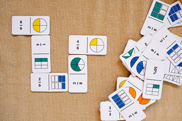 In montessori, fractions are taught with games and colored cards.