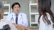 © DG PhotoStock - Asian young woman taking her mother to see an orthopedic doctor at hospital.