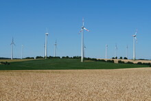 Wind Turbines For Generating Electricity In Several Fields With Crops In The State Of Bavaria In Germany