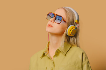 Sticker - Stylish 80s woman in eyeglasses and headphones on brown background