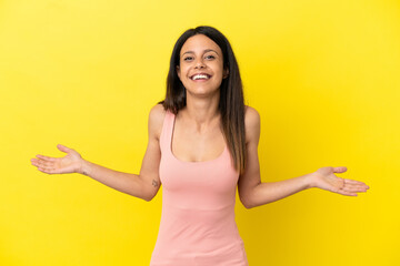 Wall Mural - Young caucasian woman isolated on yellow background happy and smiling