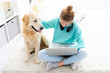 © Ievgen Skrypko - Nice teenage girl working on computer next to cute dog