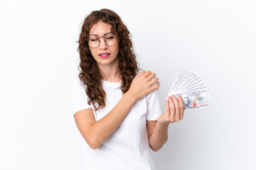 Wall Mural - Young woman with curly hair taking a lot of money isolated background on white background suffering from pain in shoulder for having made an effort