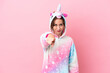 © luismolinero - Young caucasian woman with unicorn pajamas isolated on pink background points finger at you with a confident expression