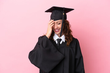 Wall Mural - Young university graduate woman isolated on pink background laughing