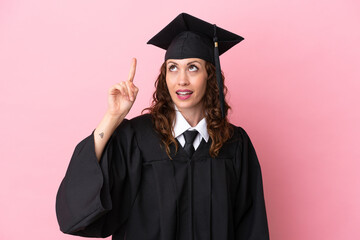 Wall Mural - Young university graduate woman isolated on pink background intending to realizes the solution while lifting a finger up