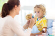 © famveldman - Sick little boy with asthma medicine. Ill child.