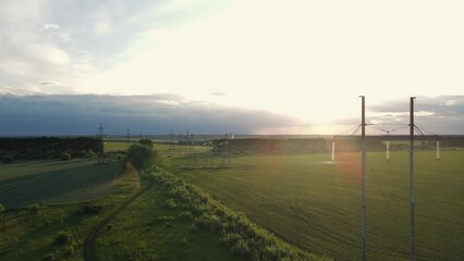 Wall Mural - High voltage power lines at the field at the sunset time