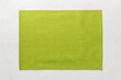 © sosiukin - Top view of green tablecloth for food on cement background. Empty space for your design