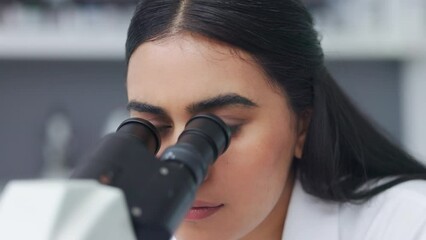 Wall Mural - closeup of a young female scientist using a microscope analysing medical test results or samples in 