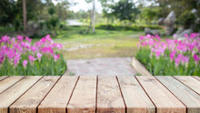 Empty Wood Table Top And Blurred Flower Tree In Garden Background - Can Used For Display Or Montage Your Products.