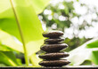 Stack pyramid stone zen pebbles nature on wooden with blur green nater outdoor. meditation tranquil calm still balance relax of buddhism religion or aroma therapy spa massage set,zen garden concept.