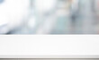 © hakinmhan - Selective focus of white table top on blur abstract background,window.