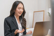 Online communication, attractive asian young woman in formal suit, using laptop computer having online virtual job interview meeting conversation on video call, distance remote recruitment conference.