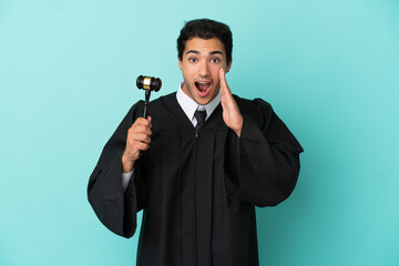 Wall Mural - Judge over isolated blue background with surprise and shocked facial expression