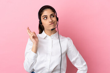 Poster - Young telemarketer over isolated background with fingers crossing and wishing the best