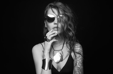 Wall Mural - Beautiful sexy woman with tattoo. tattooed girl in sunglasses and jewelry. cheerful model