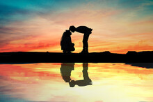Silhouette Of Loving Couple At Sunrise. Love And Romance Concept.