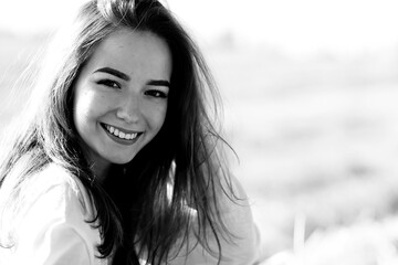 Wall Mural - black and white portrait of a cheerful girl country style, freedom young female in a field of straw