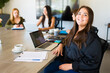 © AntonioDiaz - Young woman at a work meeting feeling happy