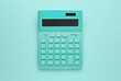 © New Africa - Turquoise calculator on light blue background, top view