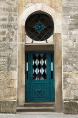 Wall Mural - View of building with blue leaded glass door. Exterior design