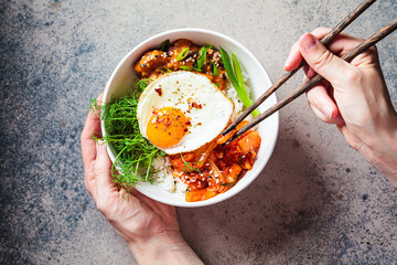 Wall Mural - Bibimbap - meat, rice, kimchi, egg and sprouts in white bowl. Traditional Korean food.