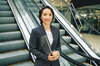 © taniasv - Portrait. Successful confident smiling middle-aged caucasian business woman looks into camera holding laptop. Confident look. Leader. Self-made woman. Senior manager. stairs escalatorl