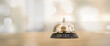 © kunakorn - Metal service bells on wooden floor Service concept and customer assistance.