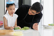© atitaph - cute father and daughter helped prepare vegetables To cook Vegetable salad